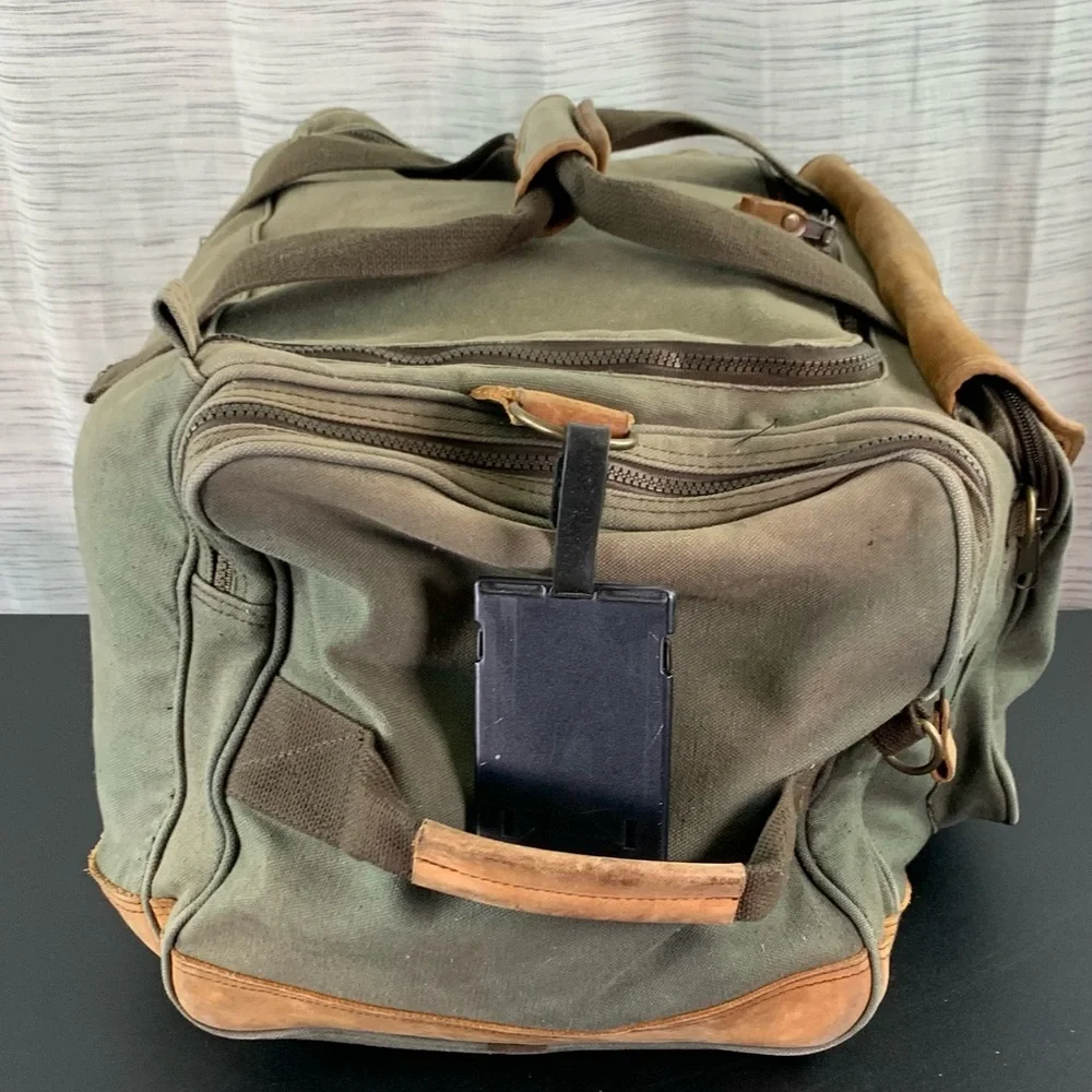 High Sierra Green canvas and Brown leather Duffel Bag.
